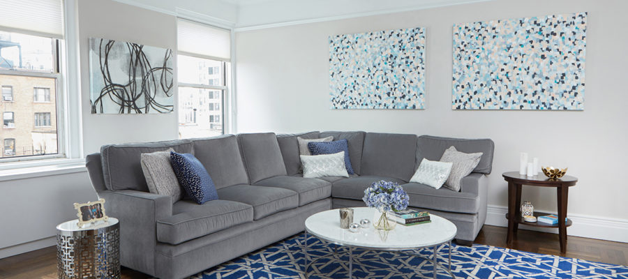 grey sectional with blue rug