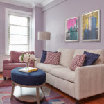purple guest room with taupe sofa and blue ottoman